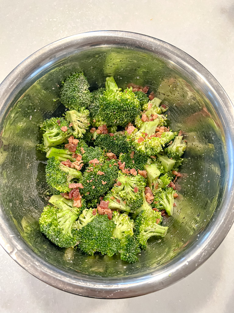 raw seasoned broccoli in a bowl