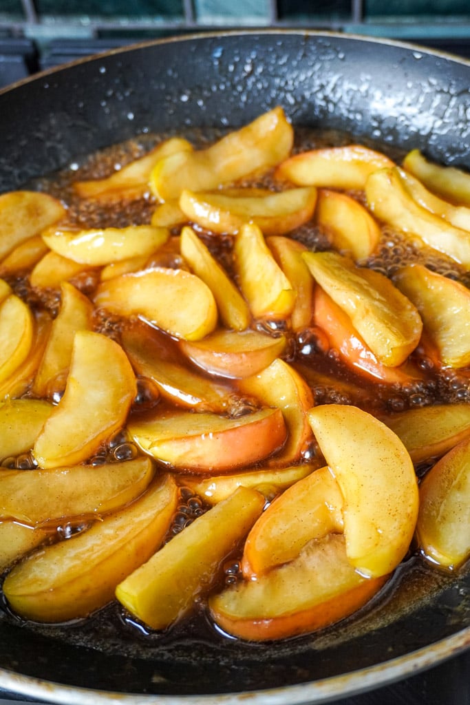 sliced apples frying in a pan