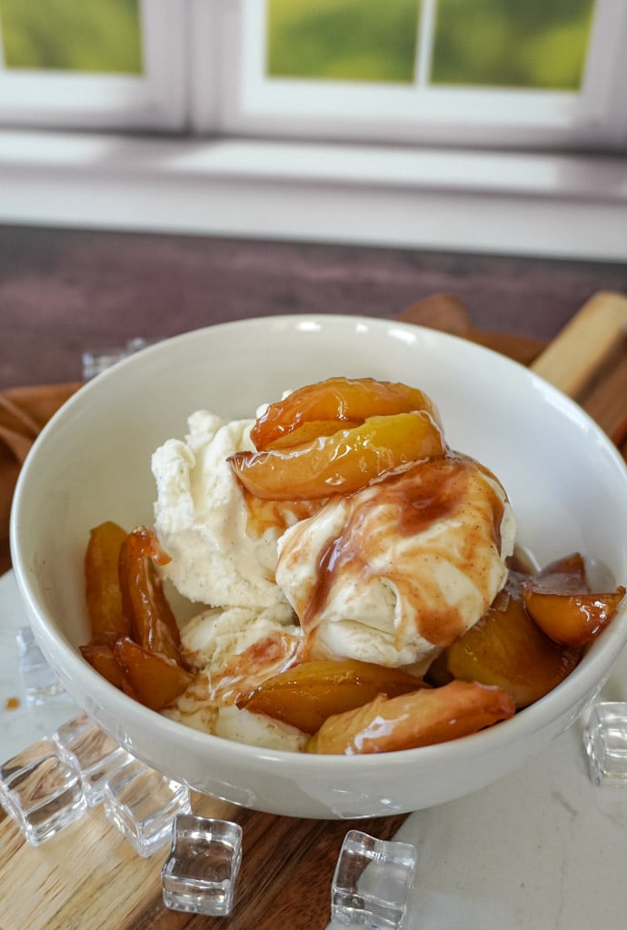 a bowl of fried apples over ice cream