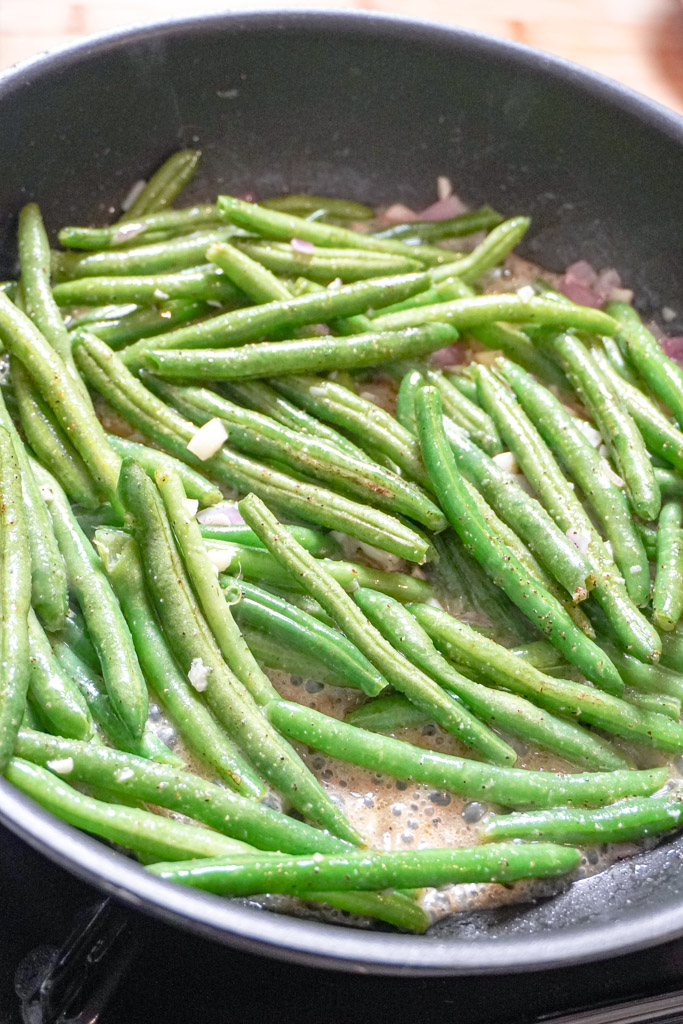 green beans sautéing in a pan