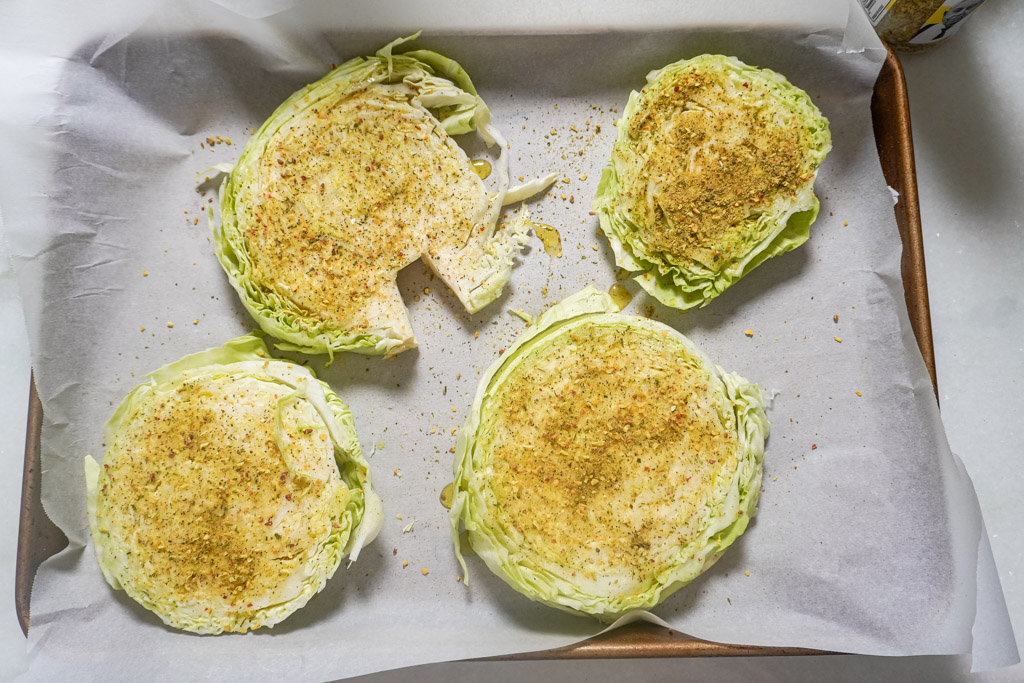 raw sliced and seasoned cabbage on parchment paper