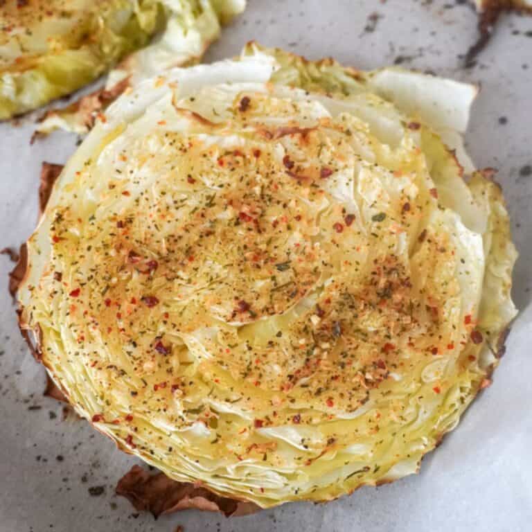 close up of cabbage steaks on parchment paper