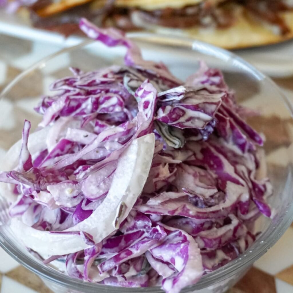 close up view of red cabbage slaw in a bowl