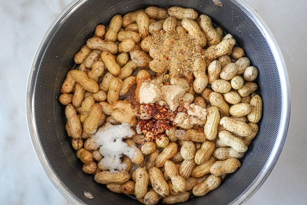 a pot full of shelled peanuts with seasoning added
