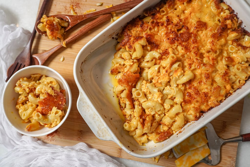 baked macaroni and cheese in a bowl next to a baking dish