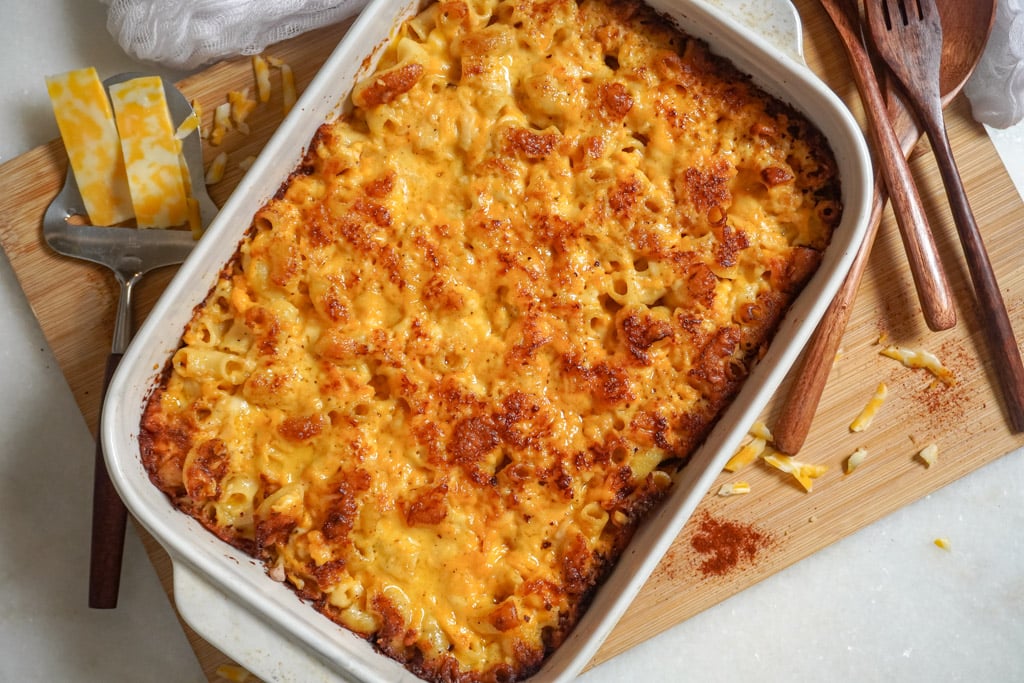baked macaroni and cheese in a bowl next to a baking dish