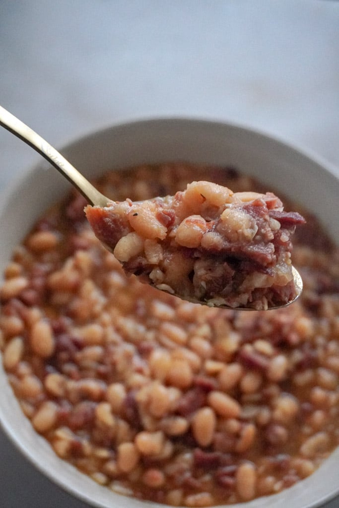 cooked navy beans and ham in a bowl