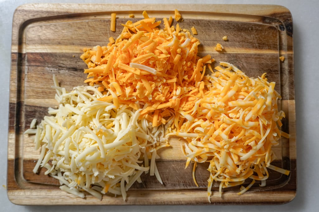 shredded cheese on a cutting board