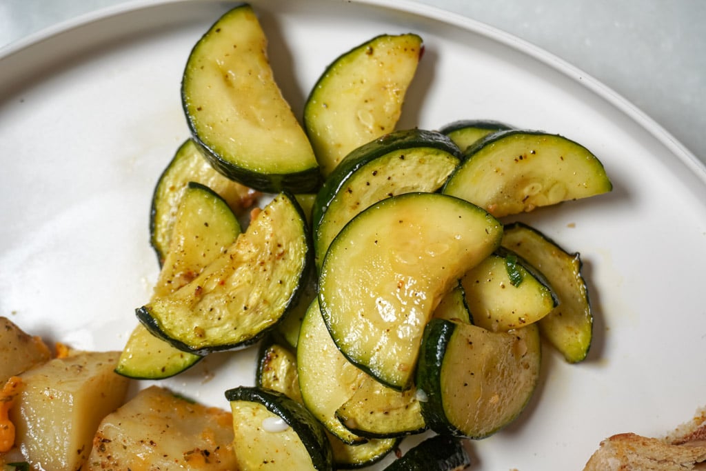 close up view of air fryer zucchini on a plate