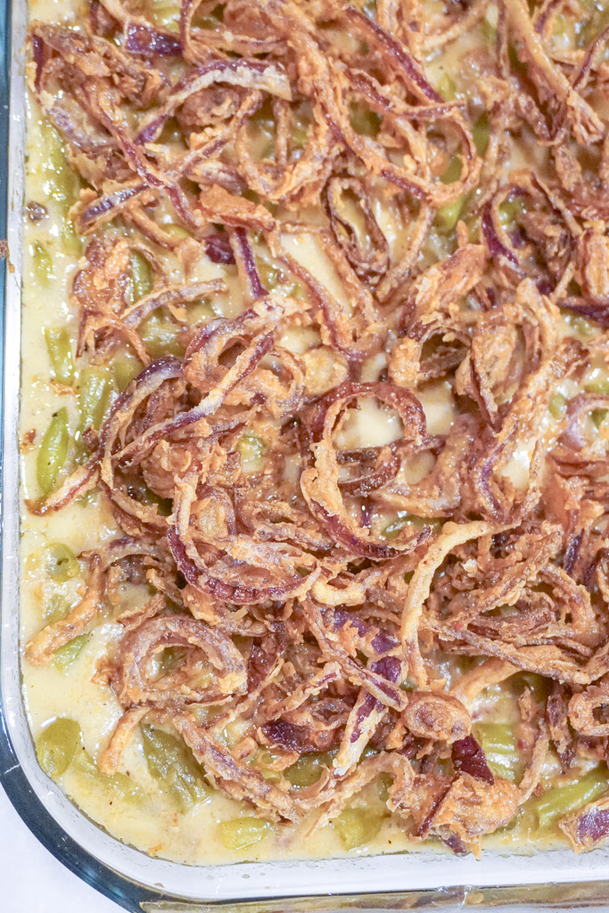 close up view of green bean casserole with bacon in a casserole dish