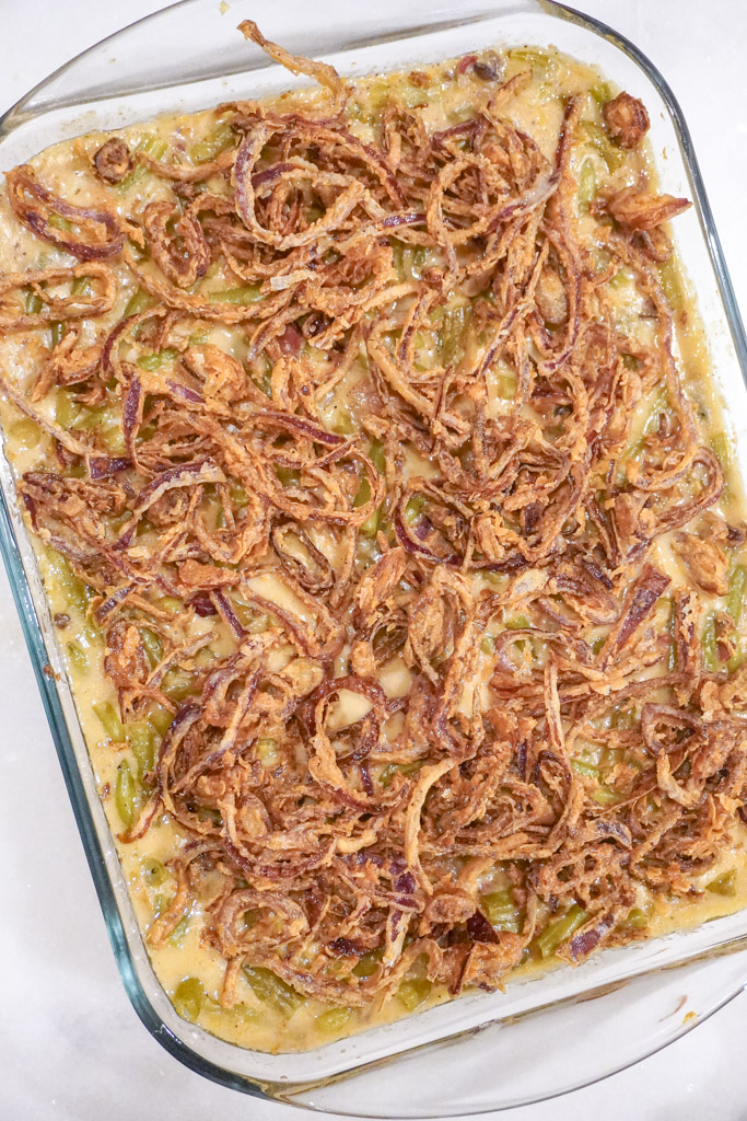 close up view of green bean casserole with bacon in a casserole dish