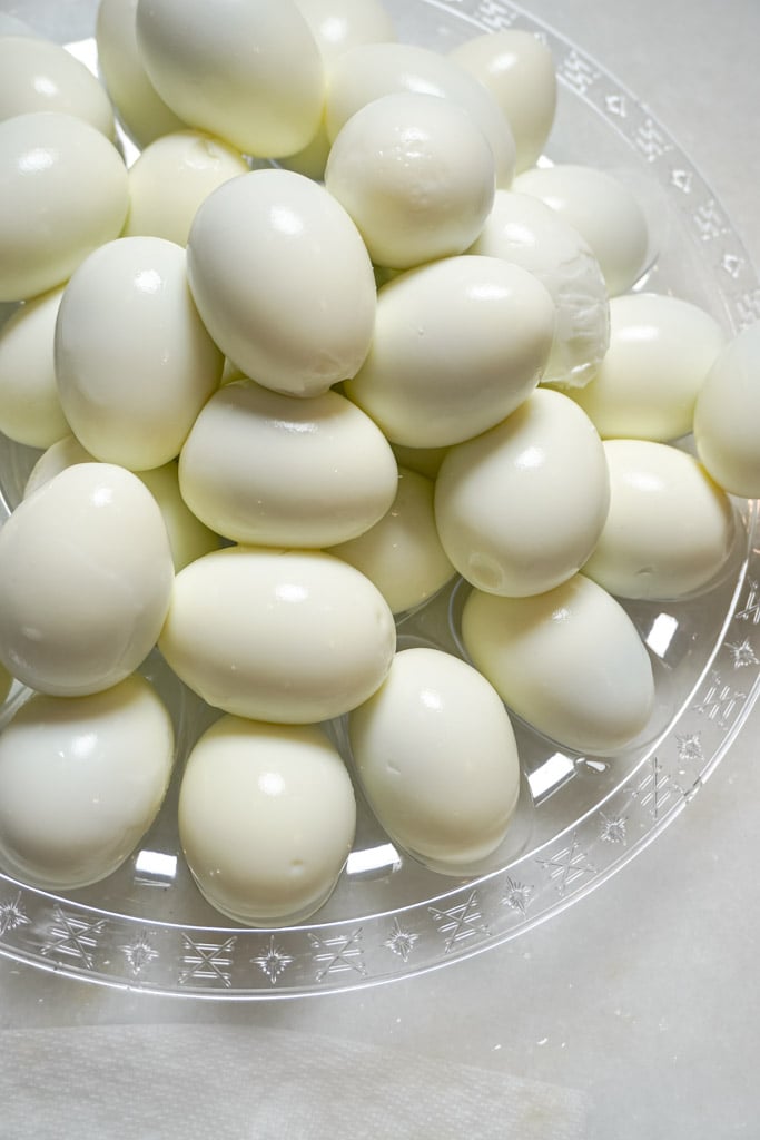 unpeeled boiled eggs in a bowl