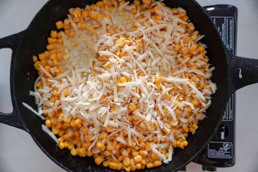 a skillet containing Korean Cheese Corn before broiling
