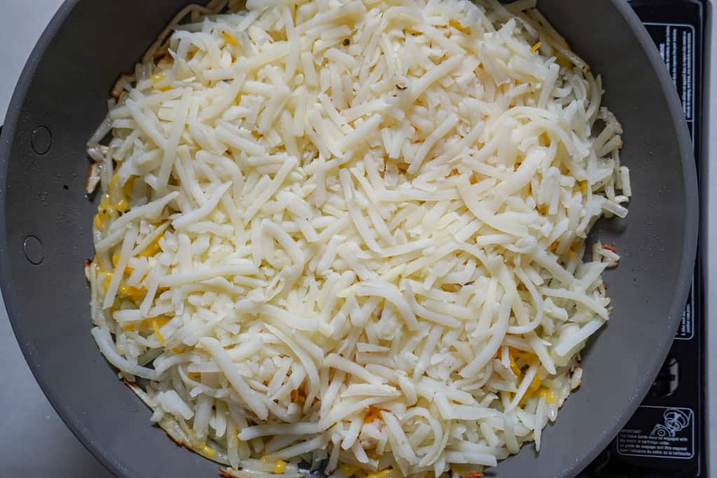 shredded potatoes in a skillet for hash brown recipe