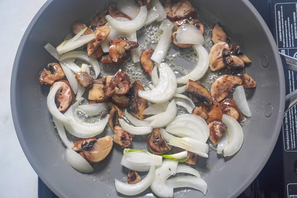 mushrooms and onions added to skillet