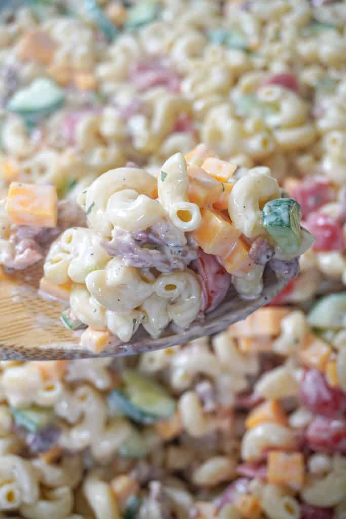 close up view of Bacon Ranch Pasta Salad with a spoon hovering in front