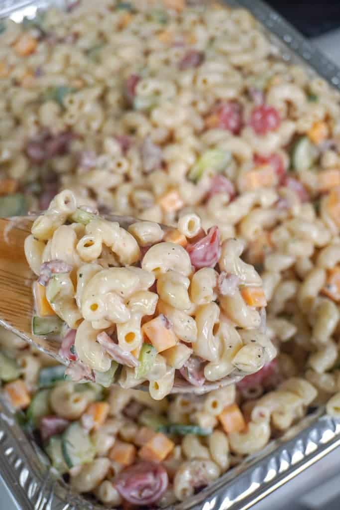 close up view of Bacon Ranch Pasta Salad with a spoon hovering in front