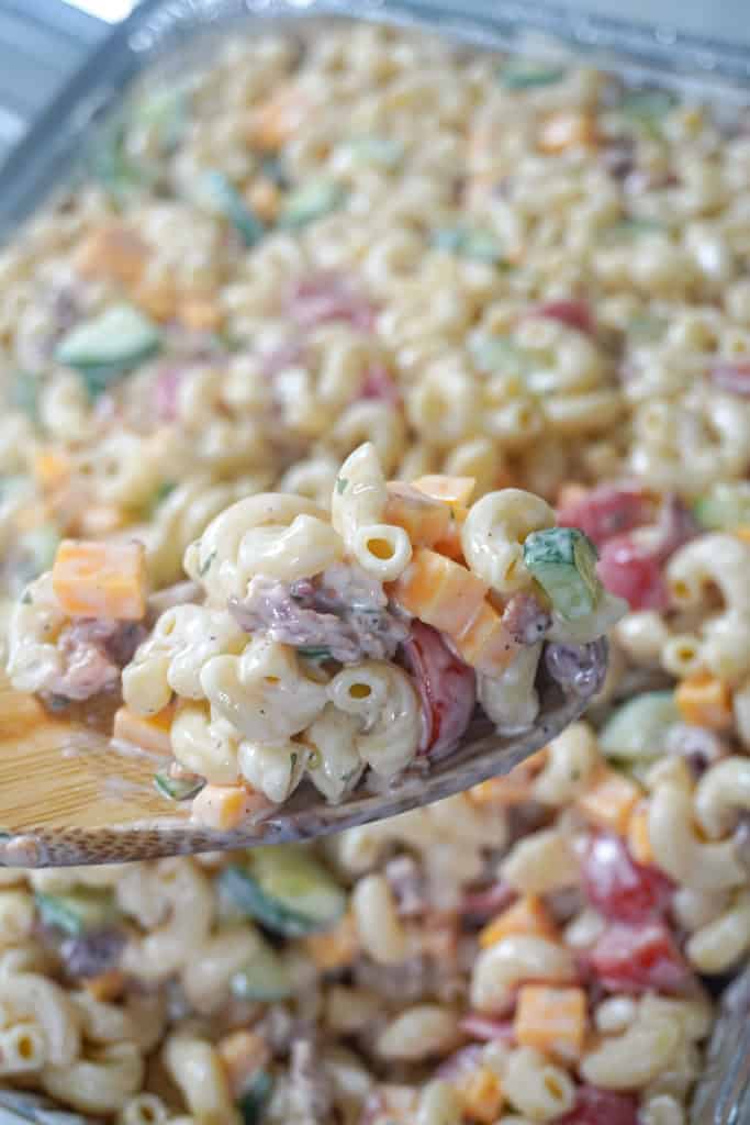 close up view of Bacon Ranch Pasta Salad with a spoon hovering in front