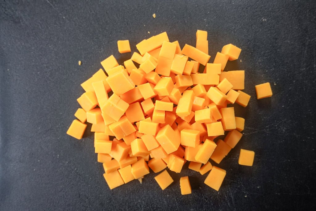 diced cheese on a cutting board