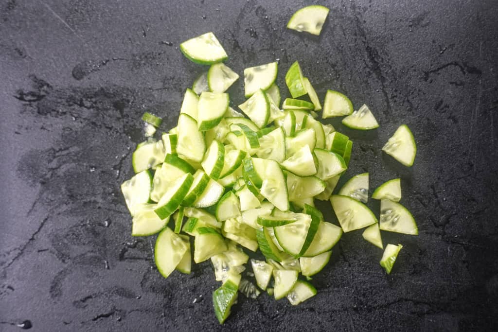 diced cucumbers on a cutting board