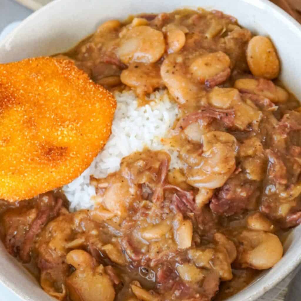 close up view of butter beans in a bowl with hot water cornbread