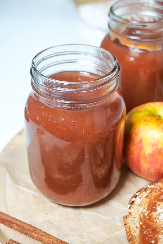 apple butter in a mason jar on a counter top