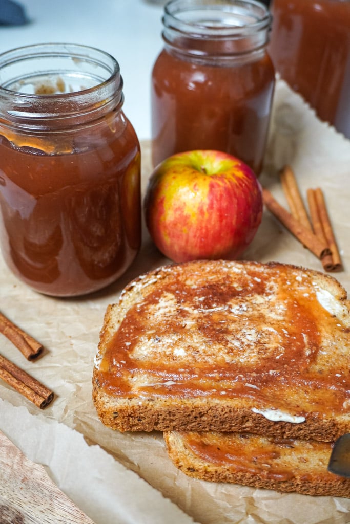 toast on a cutting board with apple butter spread on it
