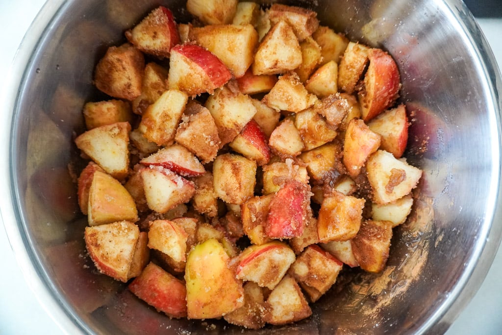 spices mixed into apples for apple butter