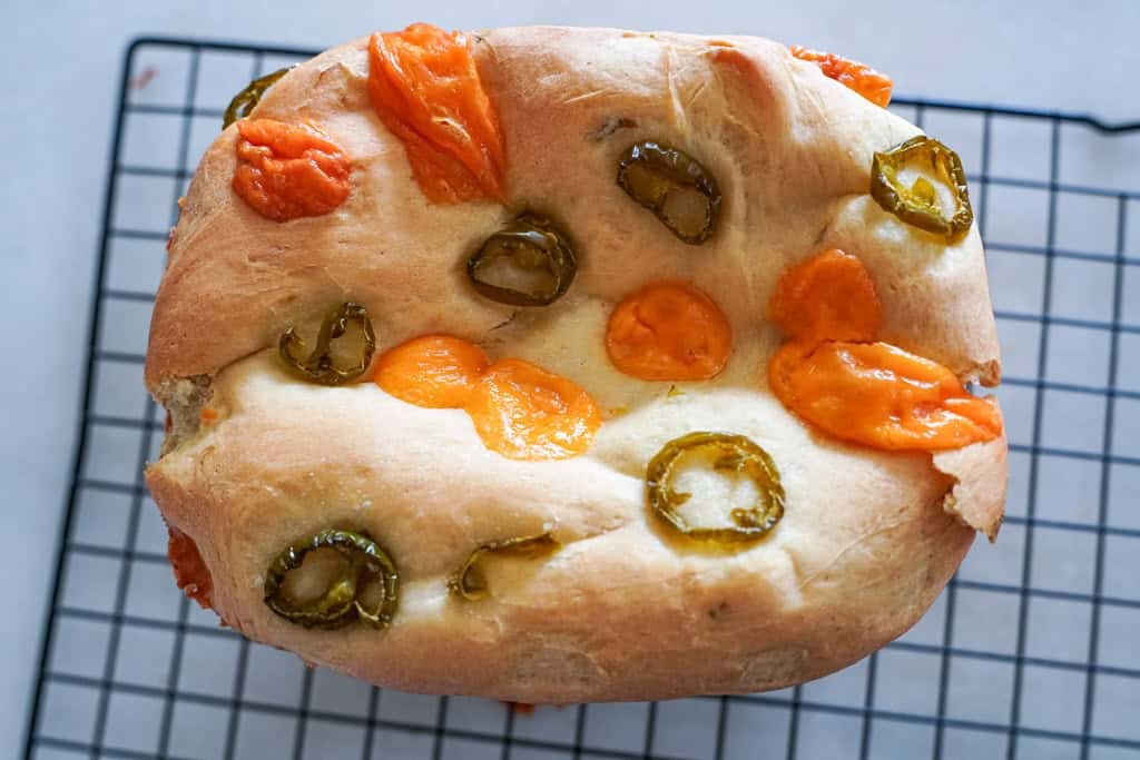 jalapeno cheddar bread loaf on a cooling rack