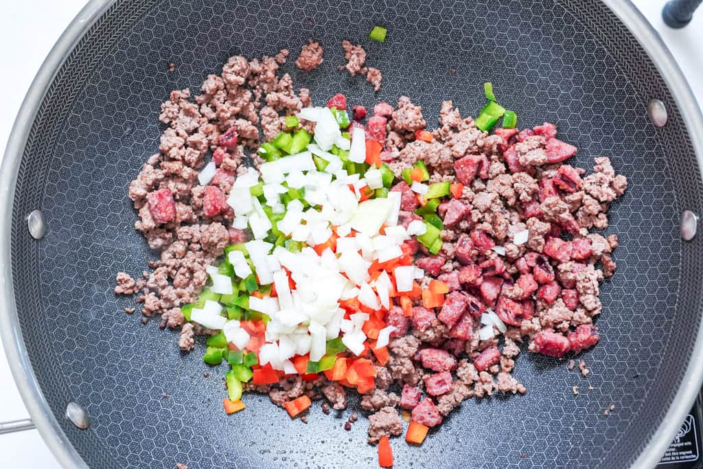vegetables and meat cooked in a skillet for dirty rice recipe
