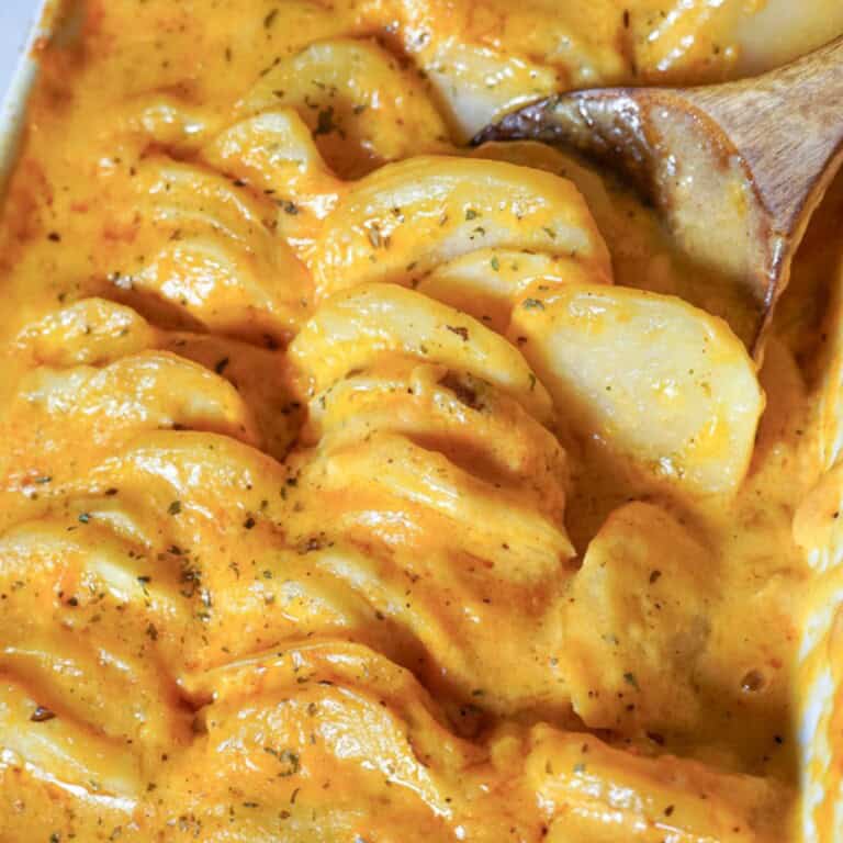 potatoes au gratin in a white baking dish