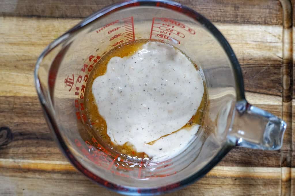 caesars and italian dressing combined in a measuring cup