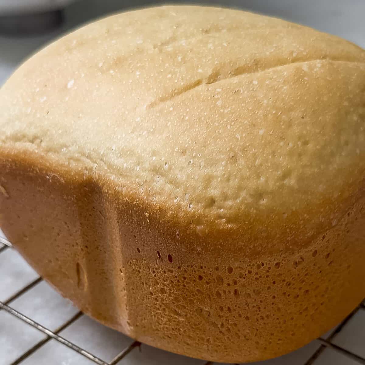 loaf of white bread on a cooling rack